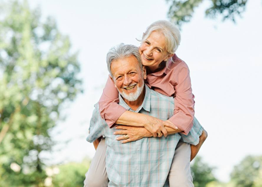 Older couple smiling and enjoying the outdoors 