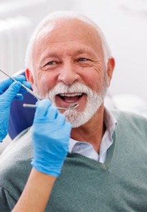 a patient smiling while getting his teeth checked