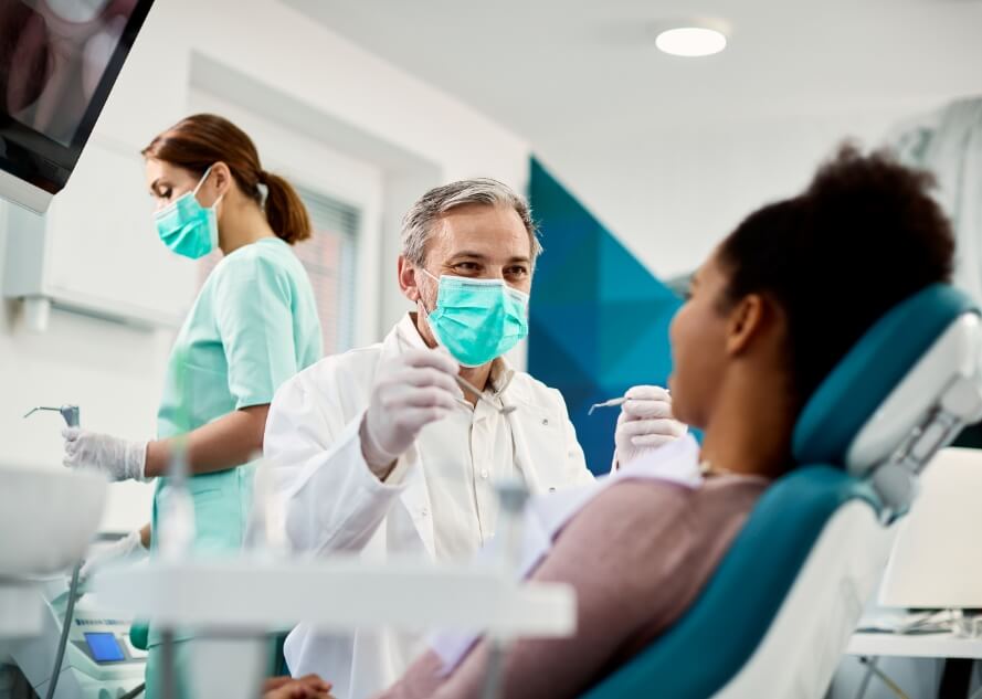 Dentist talking to dental patient