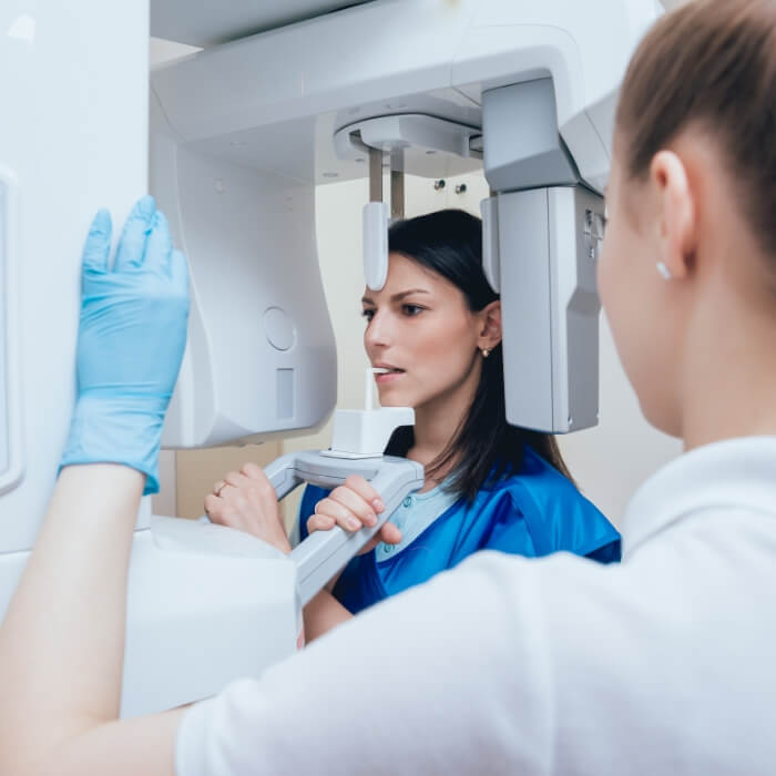 Dental patient receiving 3 D C T cone beam digital x-ray scans