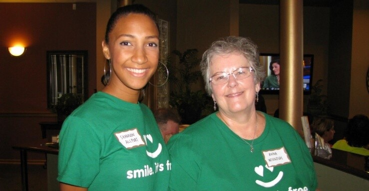 Two dental team members smiling together