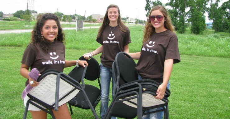 Three dental team members setting up for a community event