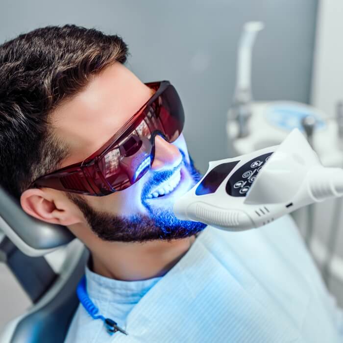 Man receiving teeth whitening treatment