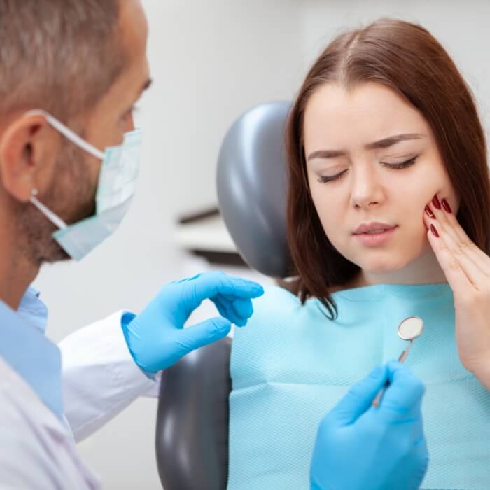 Woman in pain during emergency dentistry visit