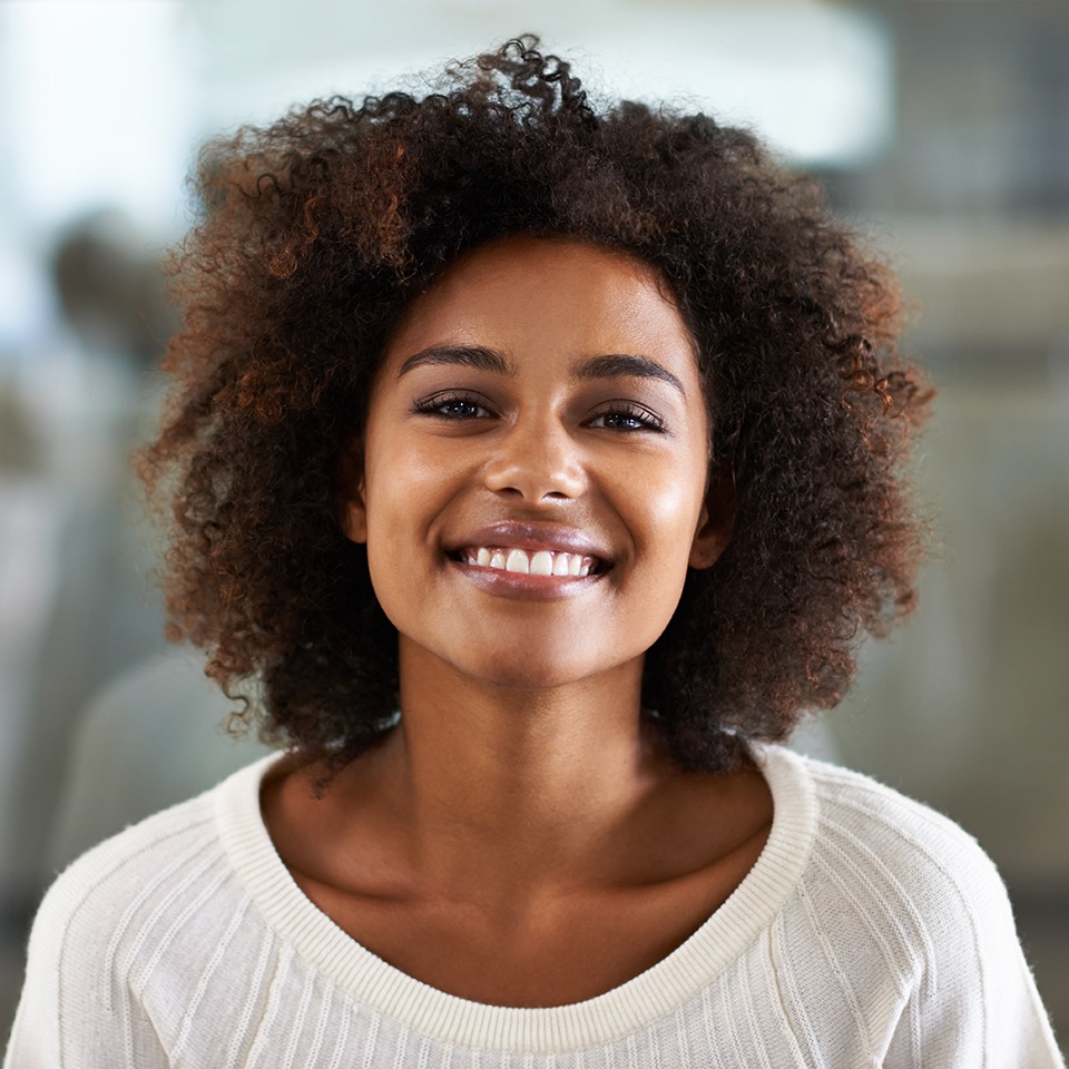 Patient in Baytown smiling confidently with natural-looking tooth-colored fillings