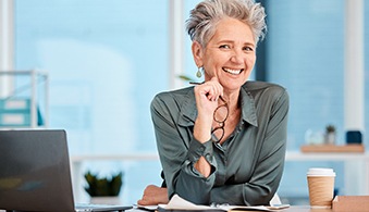 Woman smiling at a desk