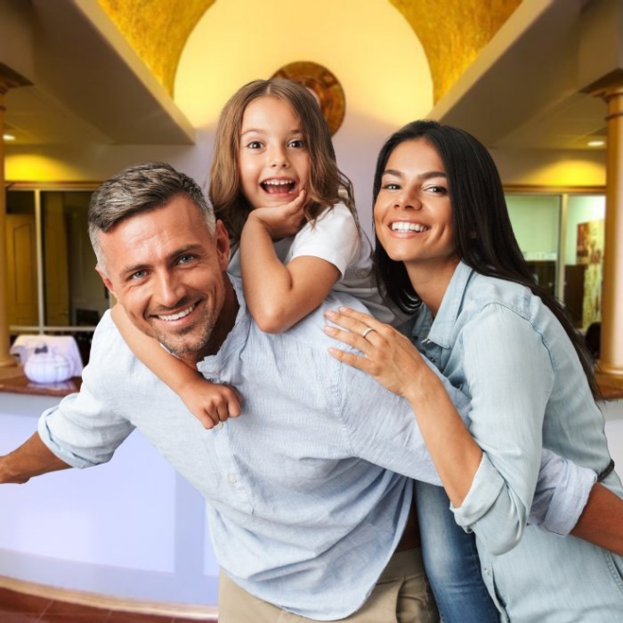 Parents and child smiling in dental office waiting room