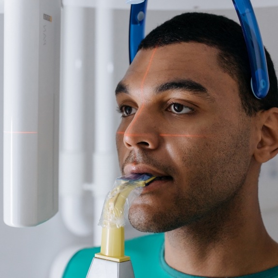 Dental patient receiving 3 D C T cone beam digital x-ray scans