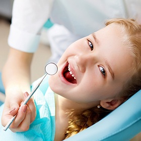 A little boy getting his teeth checked by a dentist