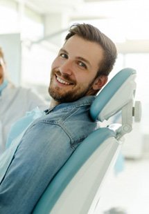 a patient smiling while visiting his dentist near Rollingbrook