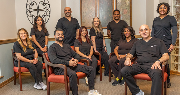 Dentist and dental patient smiling together