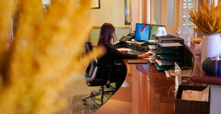 Dental team member at the dental office reception desk