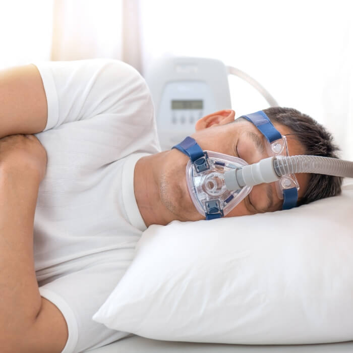 Person sleeping soundly thanks to sleep apnea treatment using C PAP system