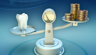 tooth and coins on a balance scale