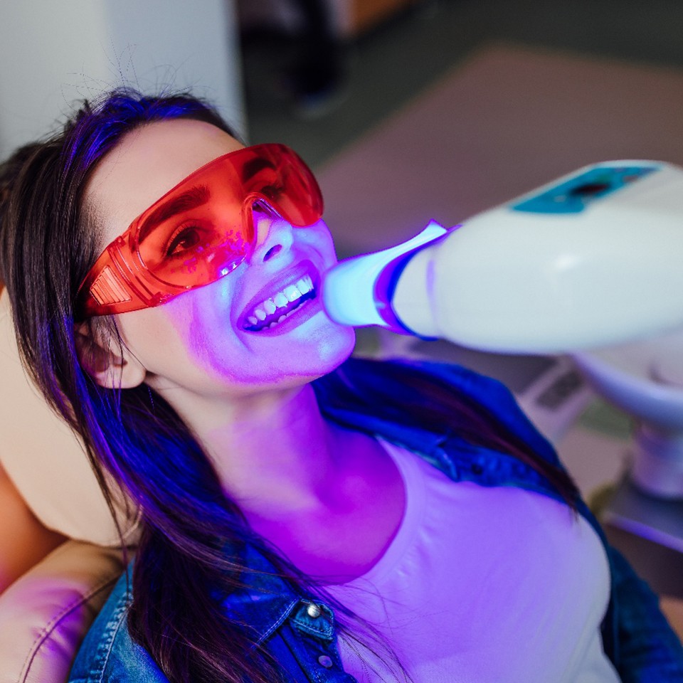 Female patient receiving professional teeth whitening in Baytown, TX