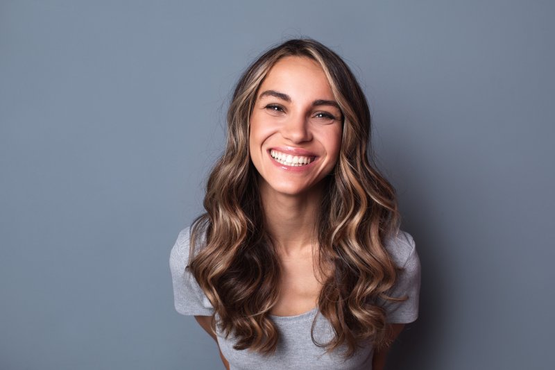 person smiling after transitioning to dental implants