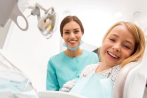 Happy little girl in dental treatment chair