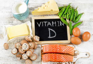 Chalkboard reading “vitamin D” surrounded by foods rich in vitamin D