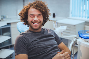 Young man sitting in dental chair smiling