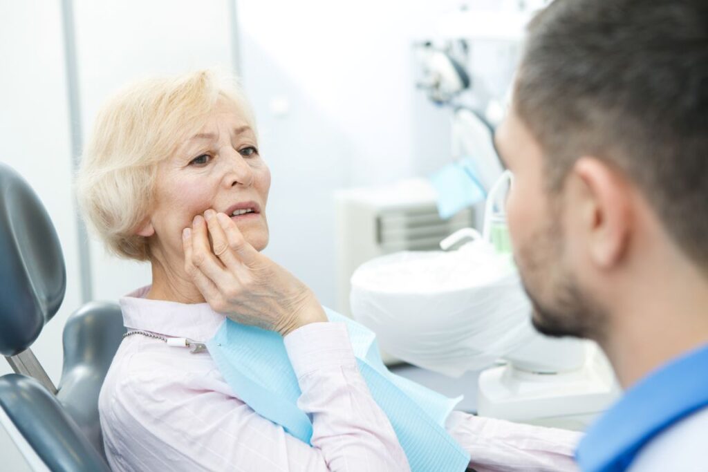 A woman at the dentist with denture sores
