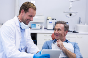 Man and dentist talking during dental implant consultation