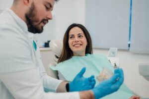 Young woman learning more about dentures for her smile