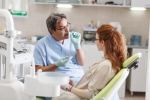 Dentist explaining something to his patient.